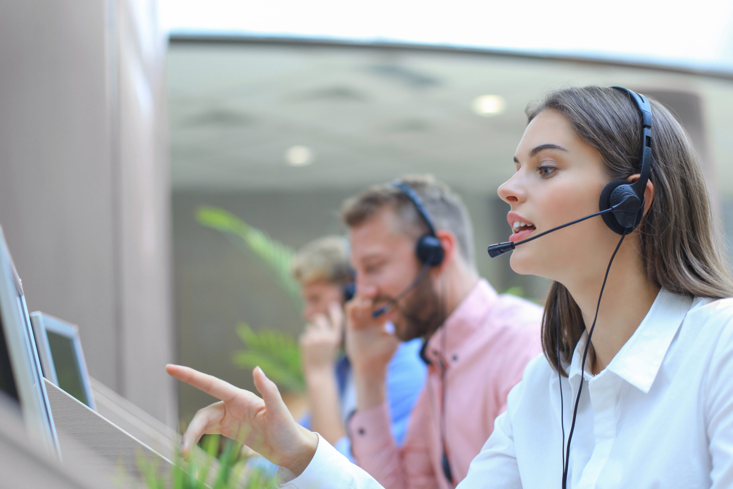 Attractive positive young businesspeople and colleagues in a call center office.